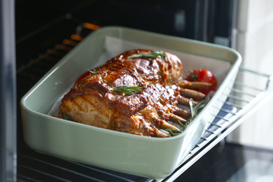 Delicious roasted ribs with tomatoes in oven