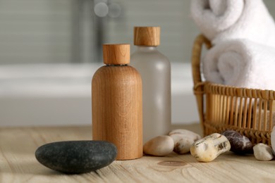 Photo of Composition with spa products on wooden table in bathroom, closeup