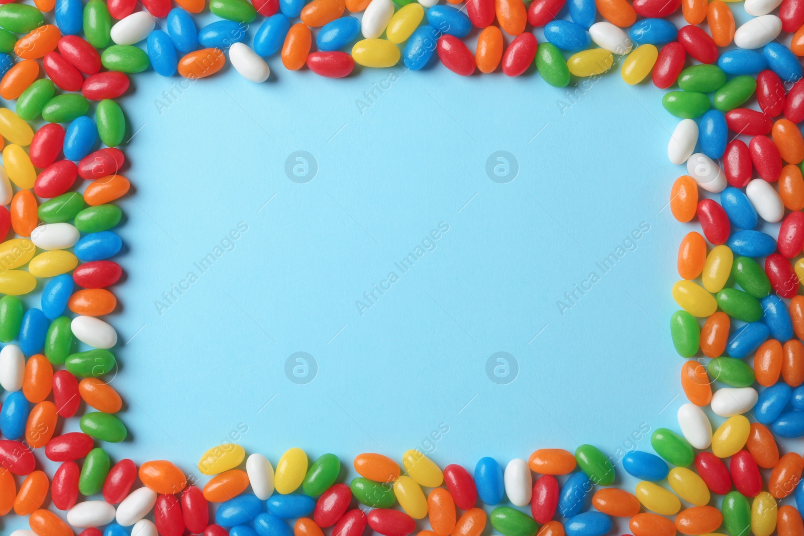 Photo of Flat lay composition with delicious jelly beans on color background. Space for text