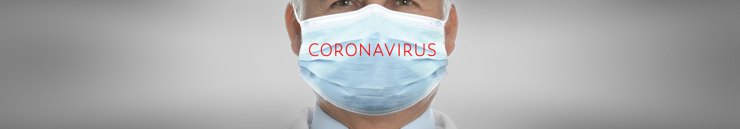 Medical worker wearing face mask on light grey background, closeup. Coronavirus safety