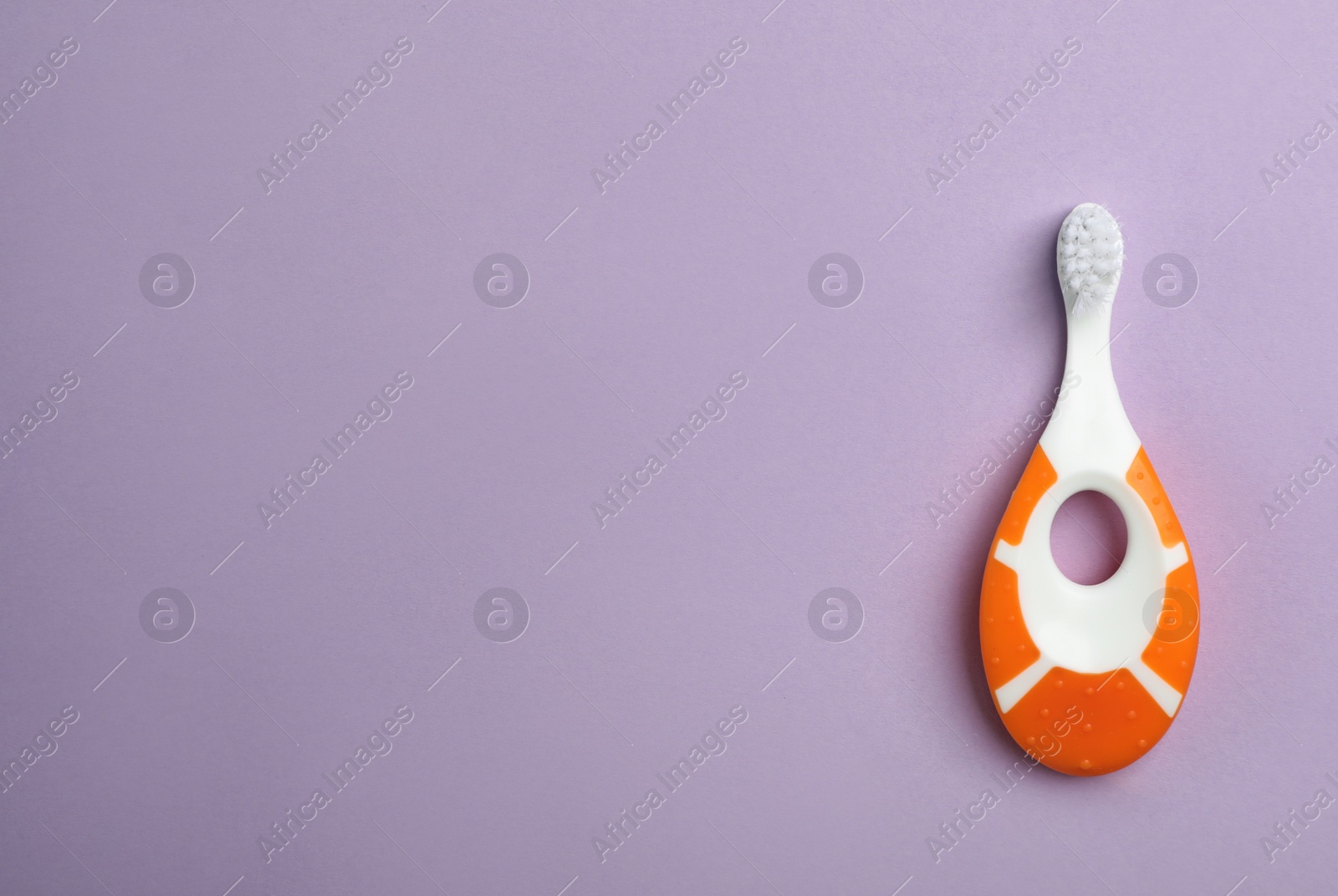 Photo of Manual toothbrush for child on color background, top view with space for text