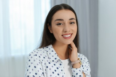 Portrait of beautiful young woman at home