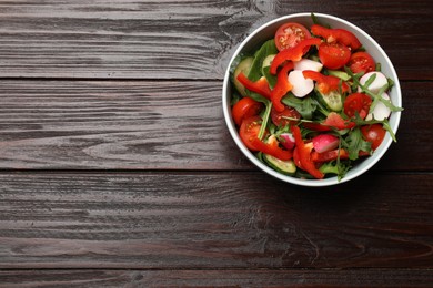 Tasty fresh vegetarian salad on dark wooden table, top view. Space for text