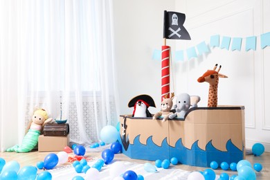 Child's room interior with pirate cardboard ship and toys