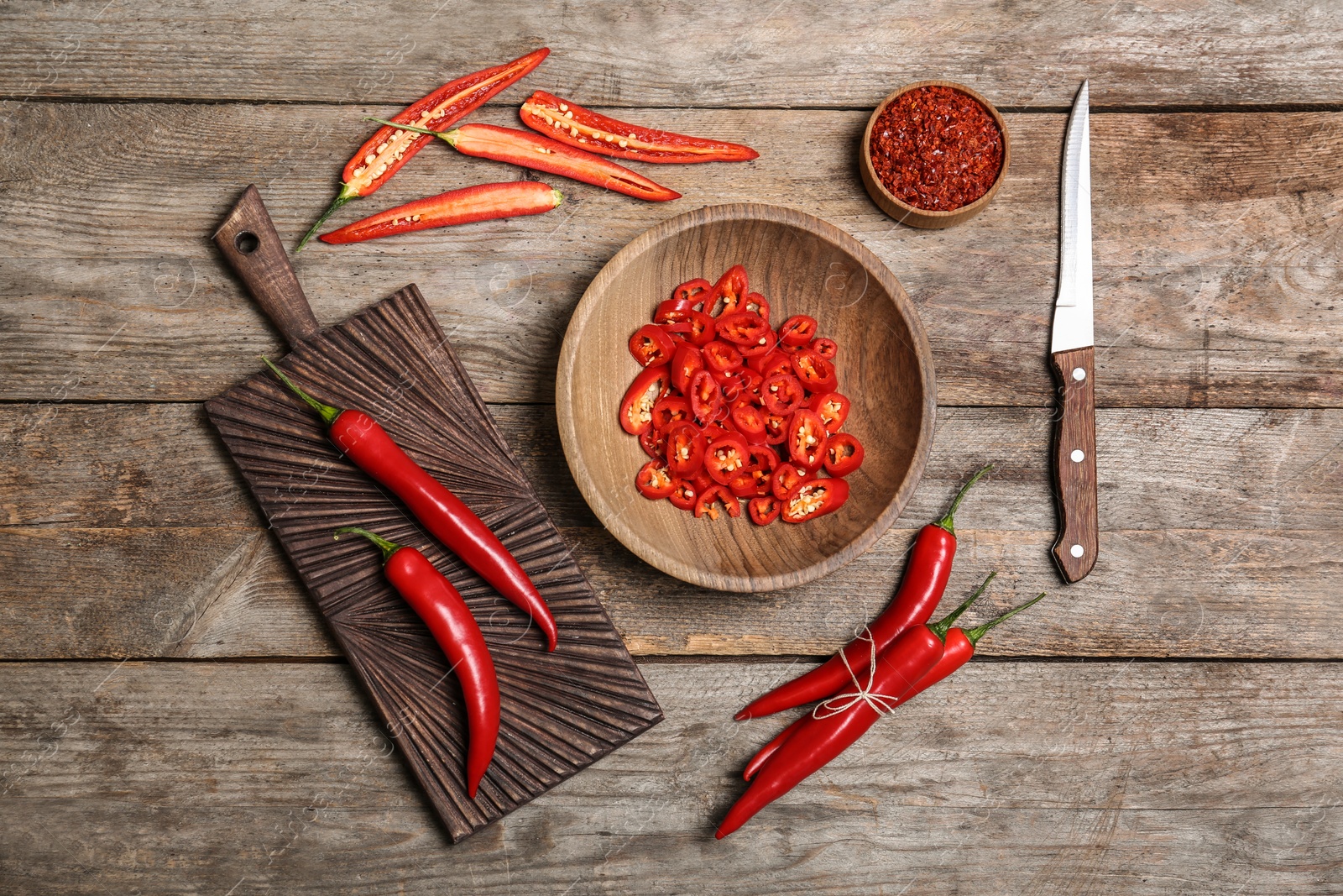 Photo of Flat lay composition with chili peppers on wooden background