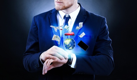 Businessman with modern smartwatch on dark background 