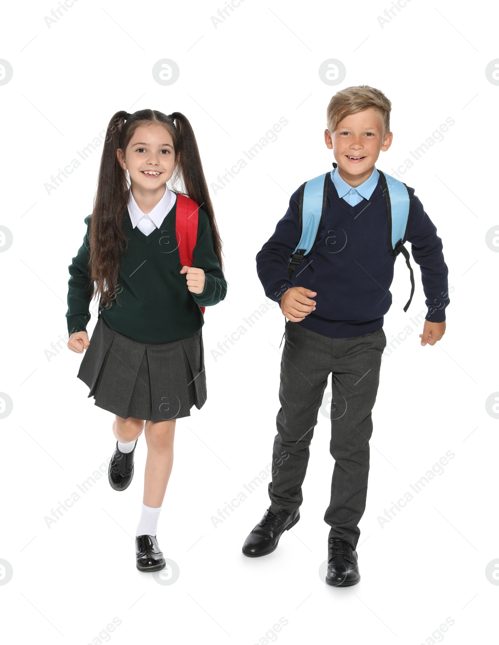 Photo of Little children in stylish school uniform on white background