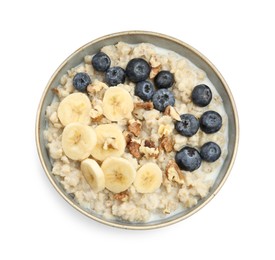 Tasty oatmeal with banana, blueberries, milk and walnuts in bowl isolated on white, top view