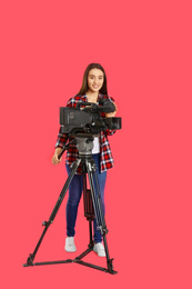 Photo of Operator with professional video camera on pink background