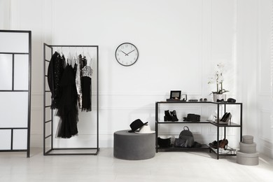 Photo of Stylish dressing room interior with trendy clothes, shoes and accessories