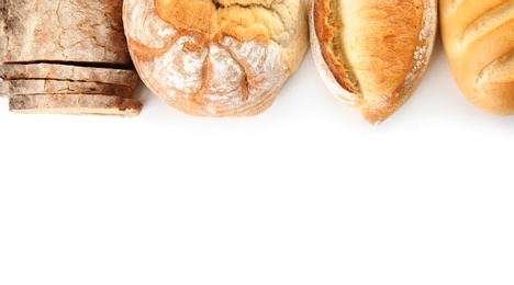 Photo of Different kinds of bread on white background, top view