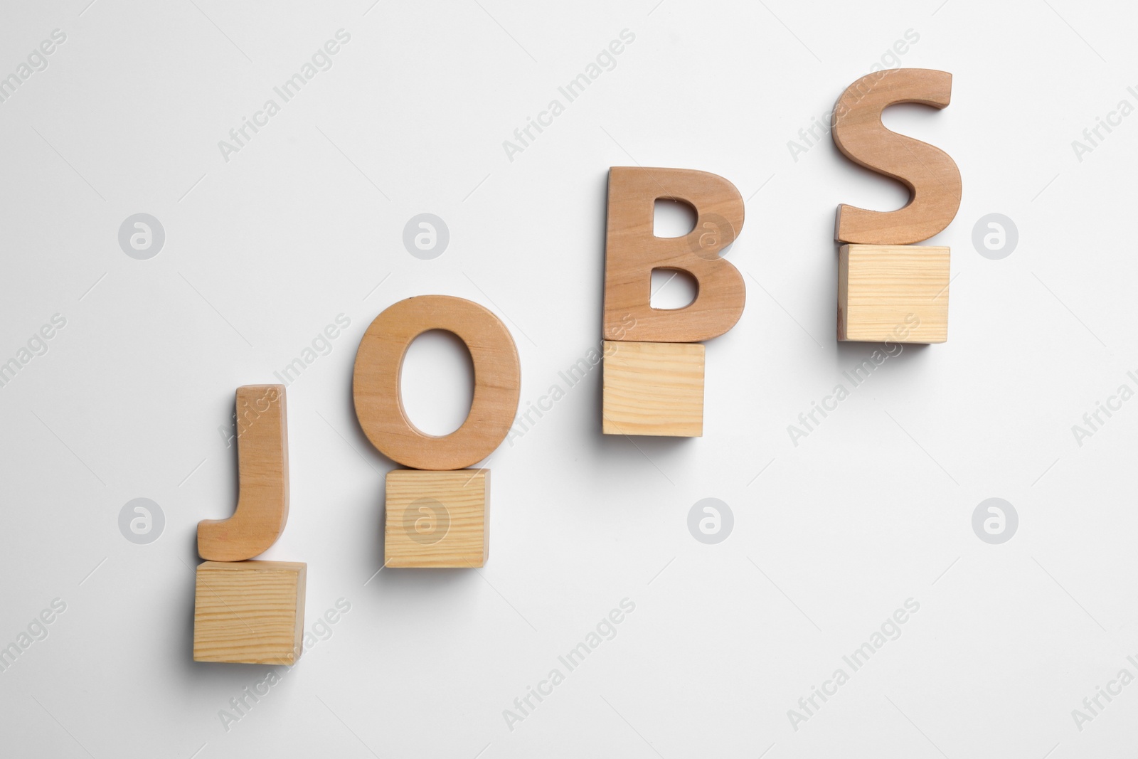 Photo of Word JOBS and wooden cubes on white background, top view. Career concept