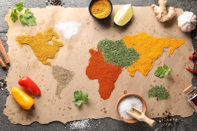World map of different spices and products on grey table, top view