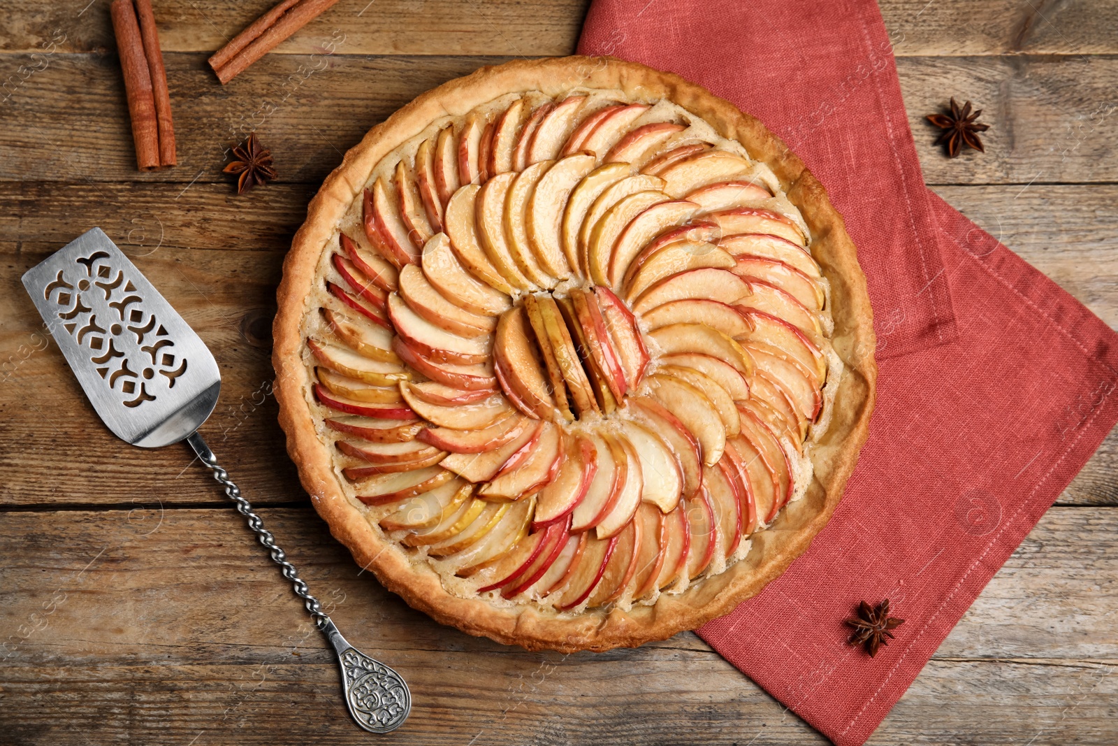 Photo of Delicious homemade apple tart on wooden table, flat lay