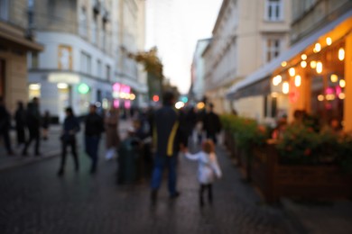 Photo of Blurred view of people walking on city street