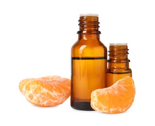 Photo of Aromatic tangerine essential oil in bottles and citrus fruit isolated on white