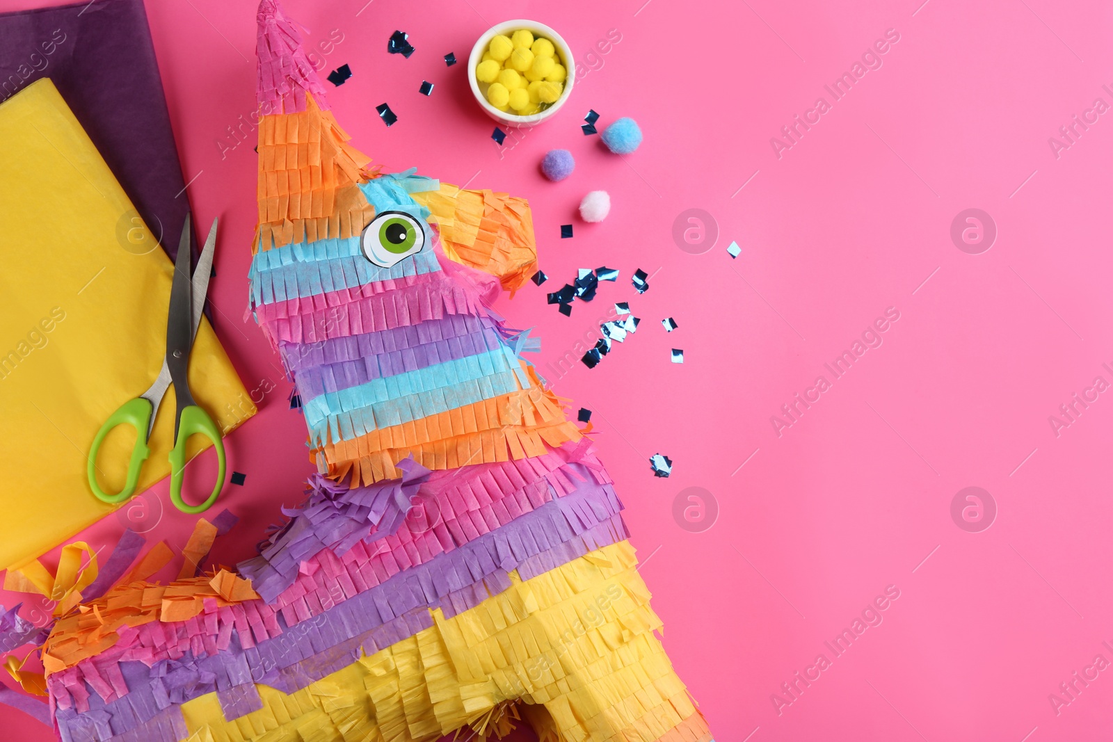 Photo of Flat lay composition with cardboard donkey and materials on pink background, space for text. Pinata DIY