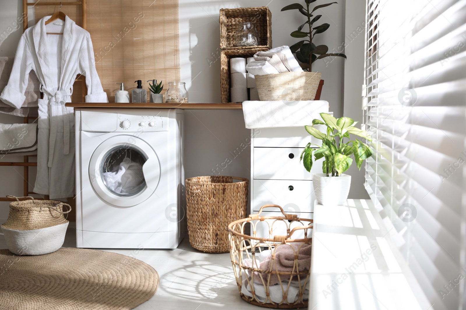 Photo of Stylish bathroom interior with modern washing machine