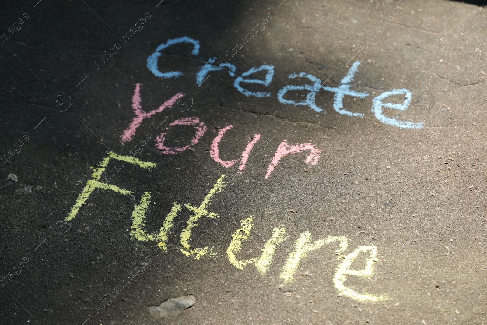 Photo of Phrase Create Your Future written on asphalt