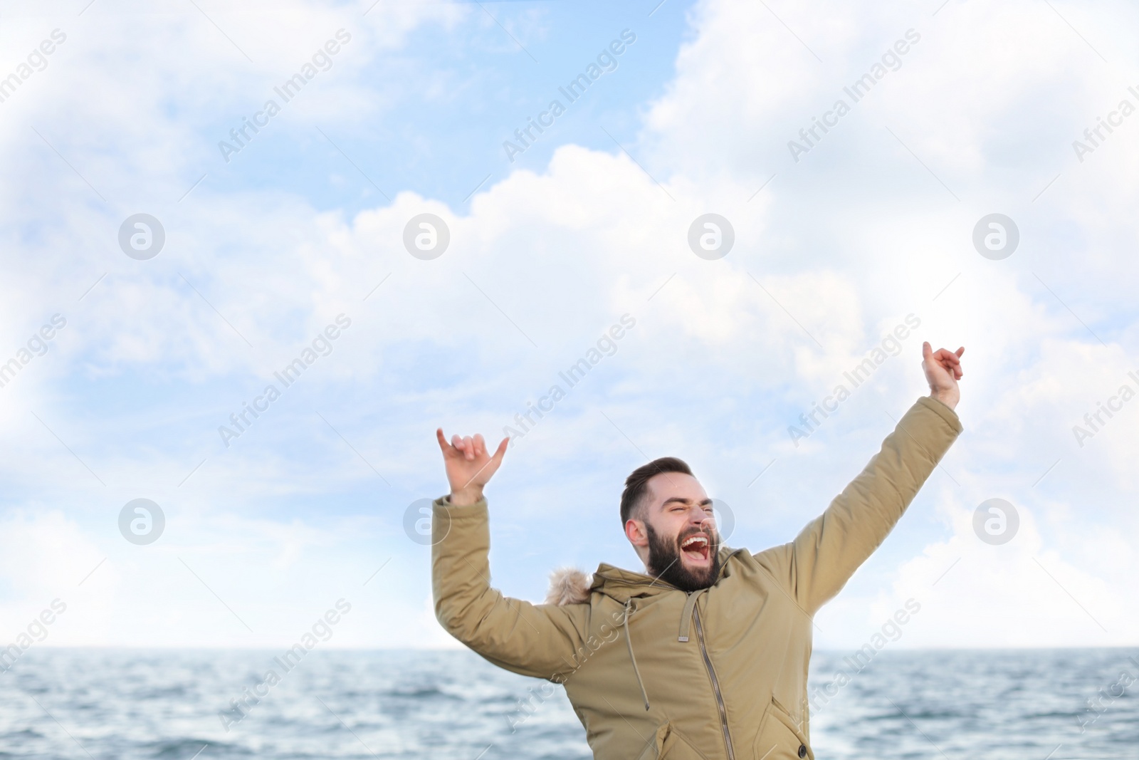 Photo of Stylish young man spending time near sea