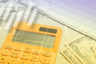 Image of Calculator, glasses, keyboard and money on table, closeup