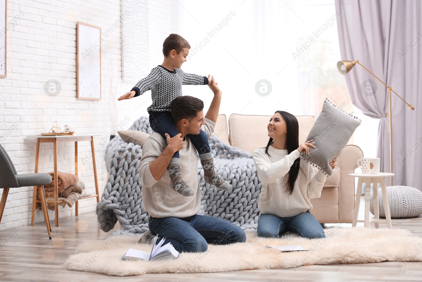 Photo of Happy family with little son having fun at home. Winter vacation