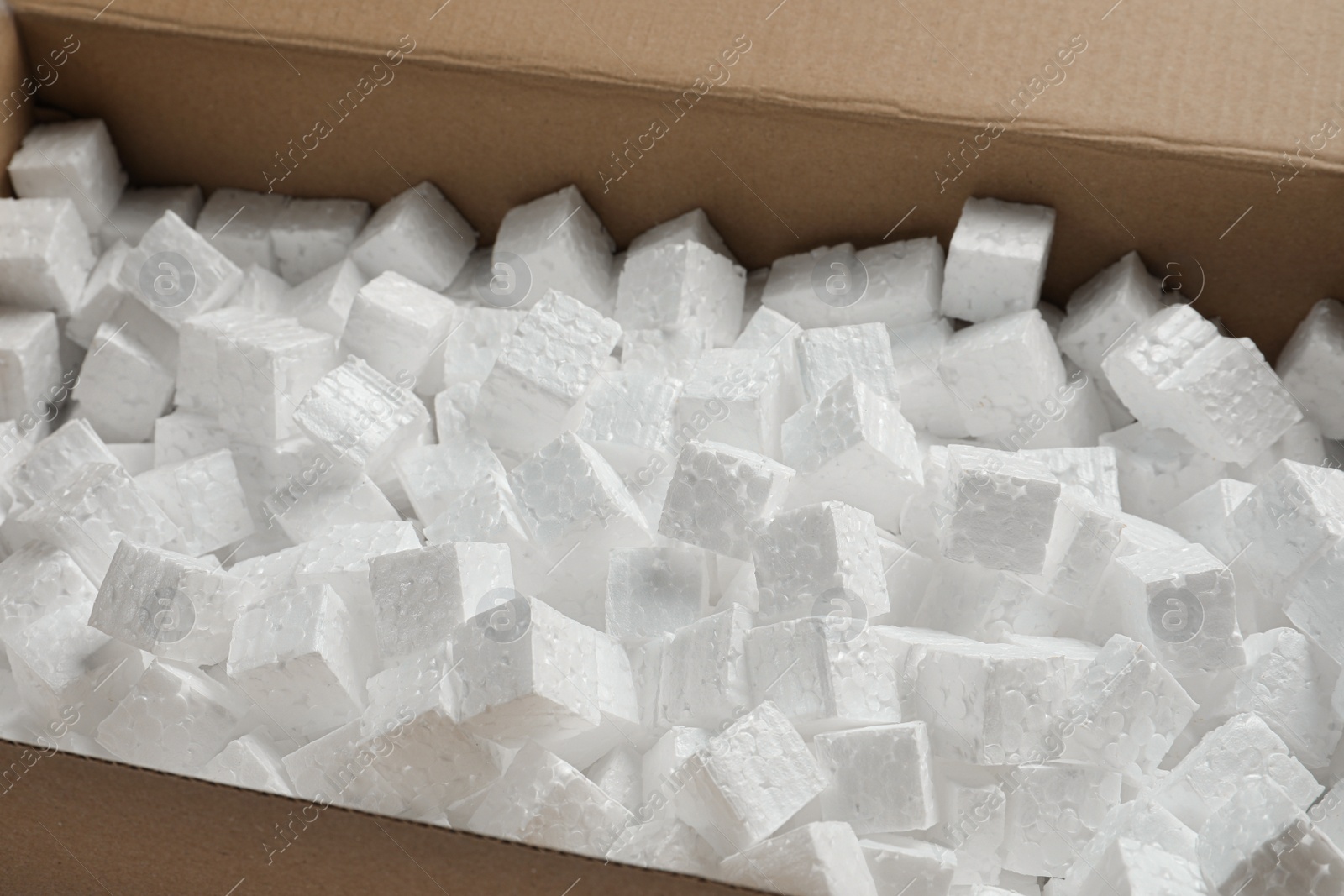 Photo of Closeup view of cardboard box with styrofoam cubes