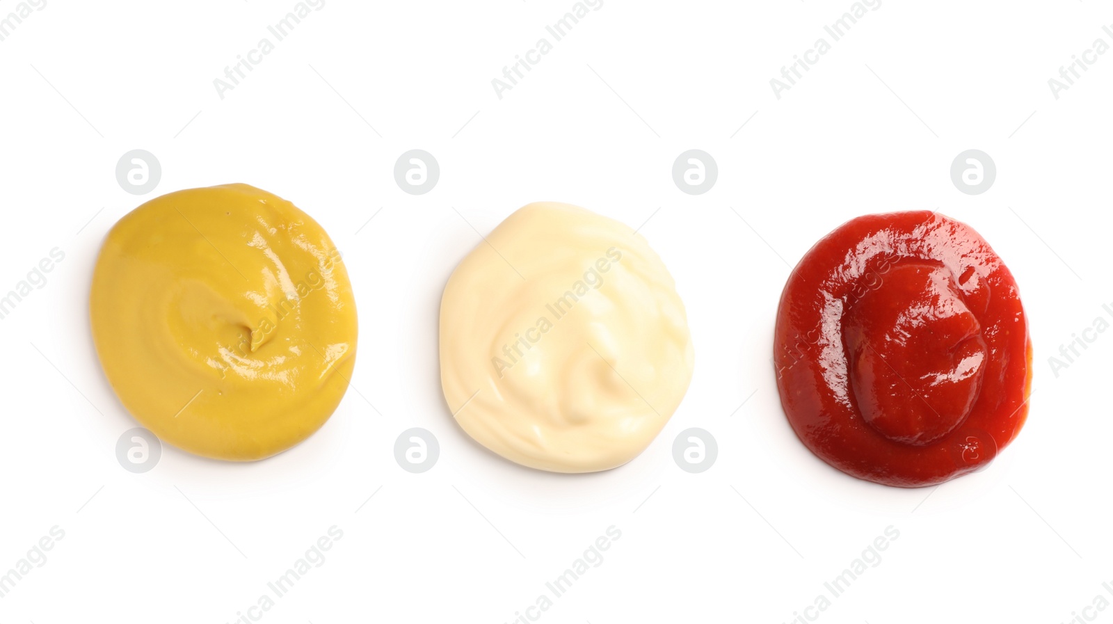 Photo of Tasty mustard, ketchup and mayonnaise isolated on white, top view