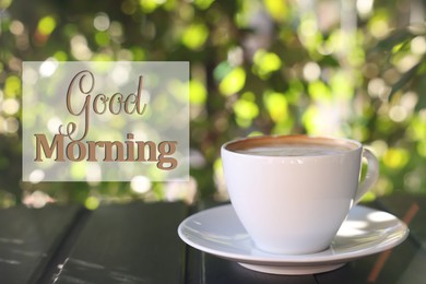 Image of Good Morning. Cup of aromatic coffee with on black wooden table outdoors