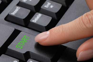 Woman pressing button with word Start on computer keyboard, closeup