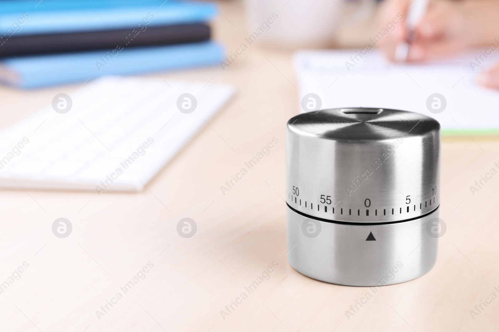 Photo of Metal kitchen timer on wooden table, closeup. Space for text