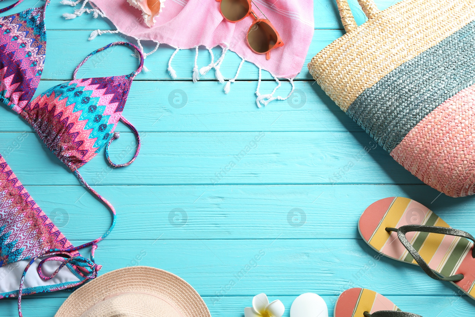 Photo of Flat lay composition with beach accessories on color wooden background. Space for text