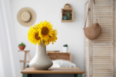 Bouquet of beautiful sunflowers on table indoors. Space for text