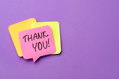 Photo of Pink paper note with phrase Thank You on purple background, top view. Space for text