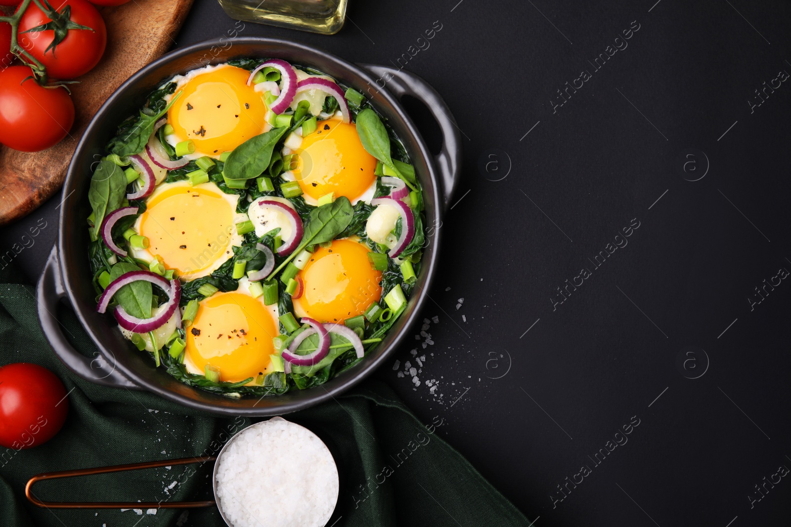 Photo of Flat lay composition with tasty Shakshouka and ingredients on black table. Space for text