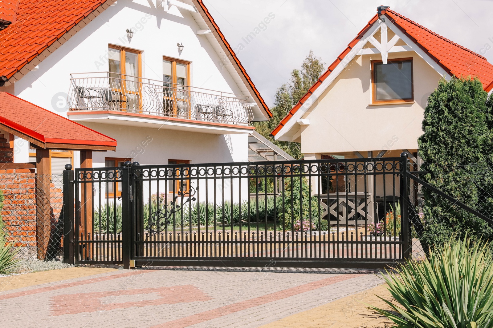 Photo of Closed metal gates near beautiful houses outdoors
