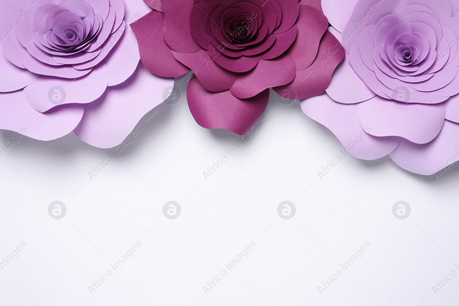 Photo of Different beautiful flowers made of paper on white background, flat lay. Space for text