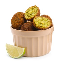 Photo of Delicious falafel balls in bowl and lime slice isolated on white