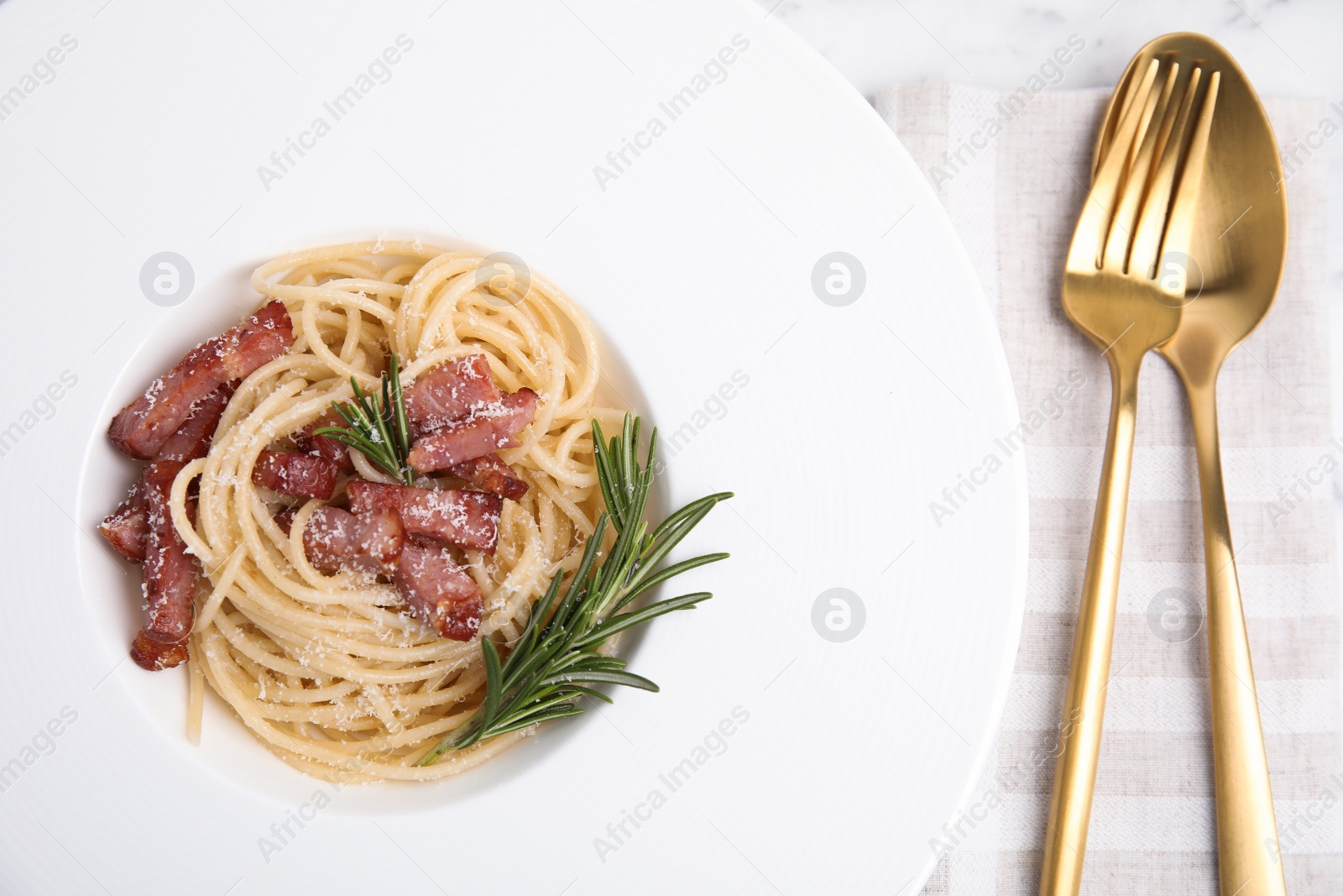 Photo of Delicious Carbonara pasta on table, flat lay