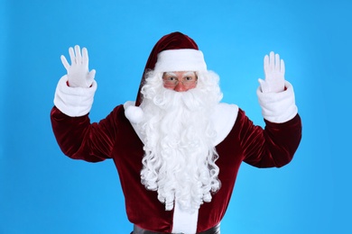 Portrait of Santa Claus on light blue background