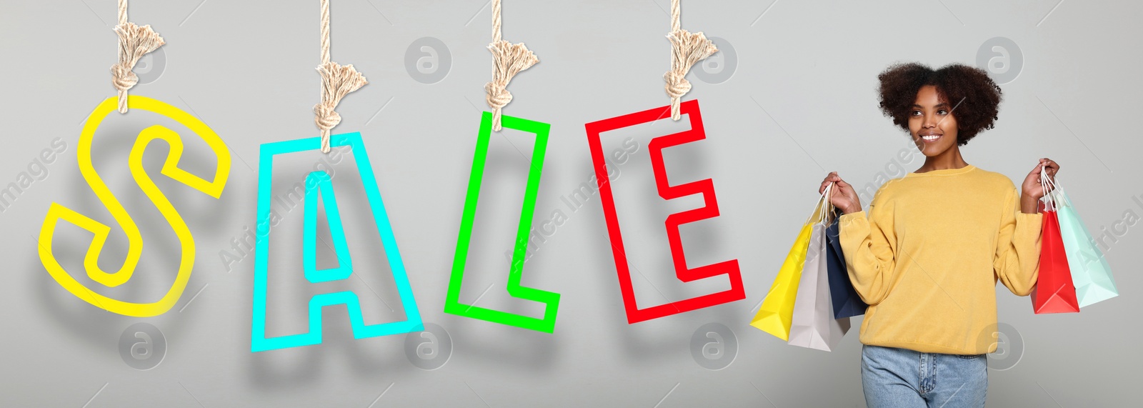 Image of Happy woman with shopping bags on light grey background, banner design. Word Sale of hanging letters