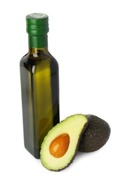 Photo of Vegetable fats. Bottle of cooking oil and fresh avocados isolated on white