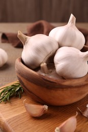 Photo of Fresh garlic on wooden table, closeup view