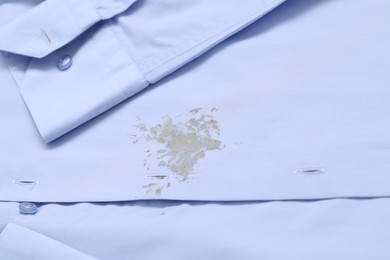 Photo of Closeup view of light blue shirt with stain