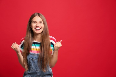 Photo of Portrait of happy woman on red background, space for text