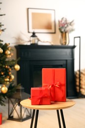 Beautifully wrapped Christmas gifts on wooden table in living room