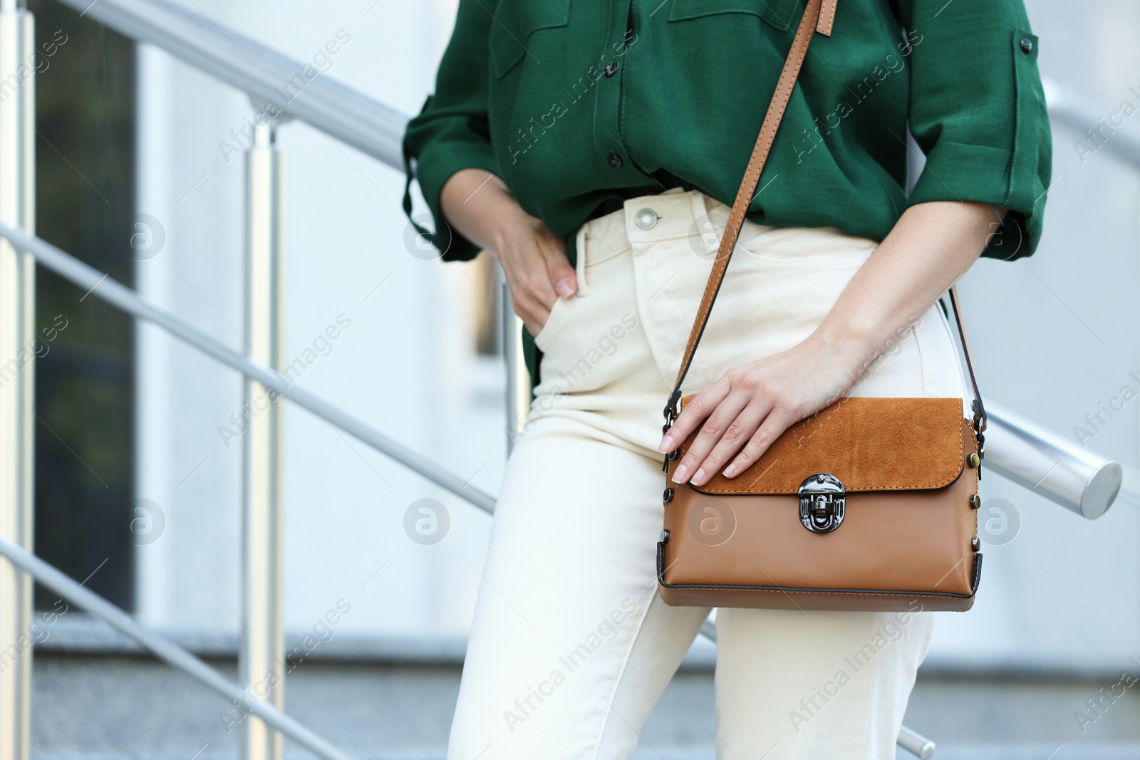 Photo of Young woman with stylish leather bag outdoors on summer day, closeup
