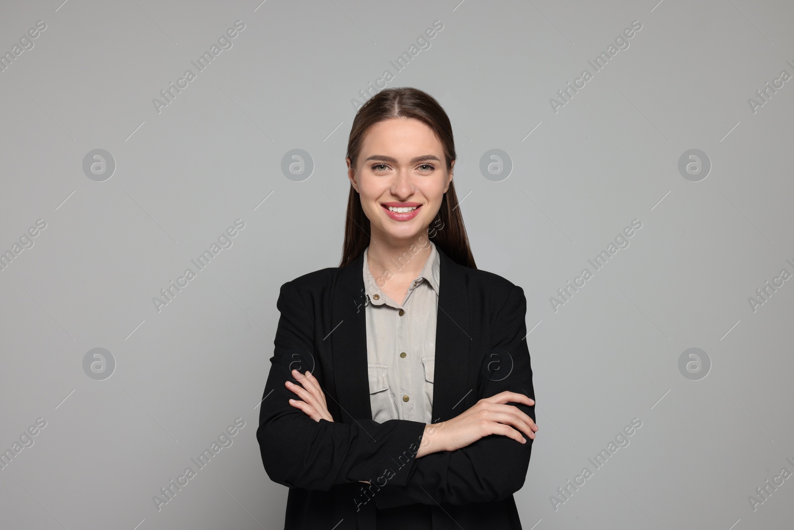 Photo of Portrait of beautiful young teacher on grey background