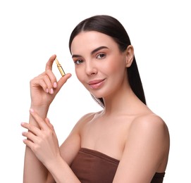 Beautiful young woman holding skincare ampoule on white background