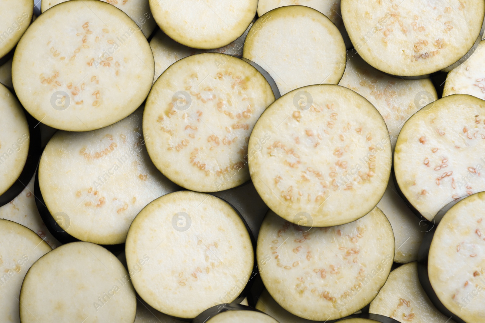 Photo of Slices of raw eggplant as background, top view